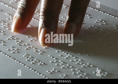 Close up of fingers reading braille Stock Photo