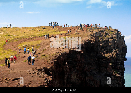 People walking to and from a viewpoint in Madeira over the Atlantic Ocean Stock Photo