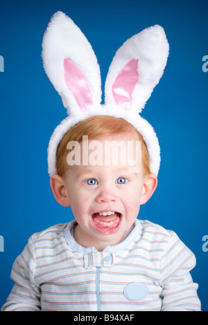 Beautiful baby wearing Easter bunny ears on head Stock Photo