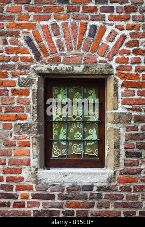 Window of a medieval building very old brick wall Stock Photo
