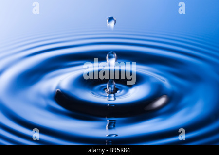 Water droplet causing ripples Stock Photo