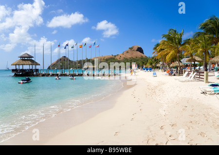 WEST INDIES Caribbean St Lucia Gros Islet Rodney Bay Sandy beach with people at Sandals Grande St Lucian with Pigeon Island Stock Photo