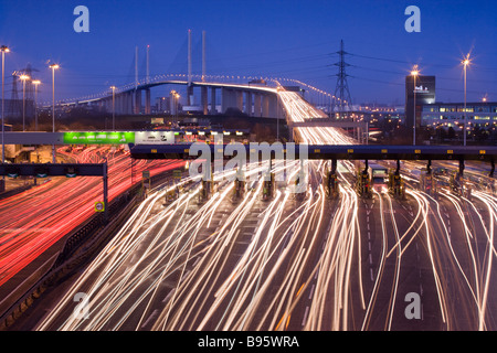 Traffic passing through toll booths at night. Queen Elizabeth II Bridge and Dartford Tunnel, Kent, UK Stock Photo