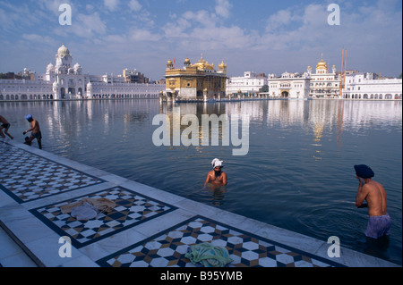 INDIA Punjab Amritsar Sikh Golden Temple Men bathing in the sacred pool surrounding the temple. Stock Photo