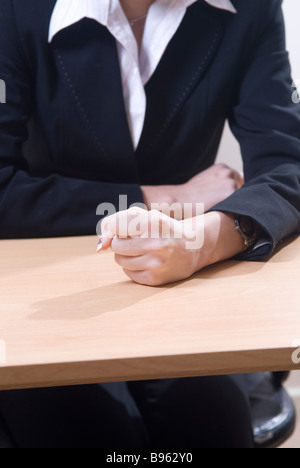 Angry Business woman fist on desk Stock Photo