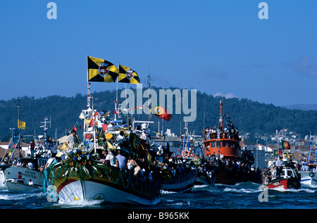 A fishing trawler taking part in the colourful Romaria de Nossa Senhora d'Agonia festivities in Viana do Castelo, Portugal Stock Photo