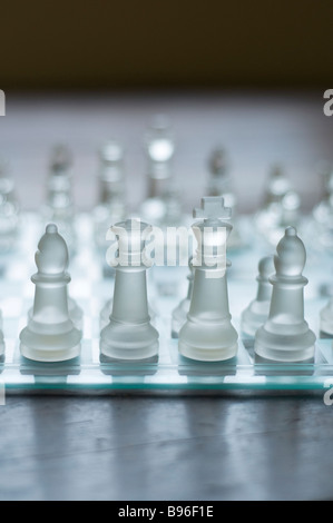 Eye level view of glass chess set on a wooden floor Stock Photo