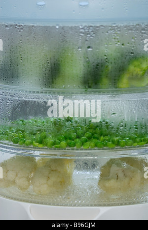 Steamer containing vegetables Stock Photo