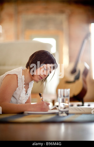 Young woman studying in urban loft Stock Photo