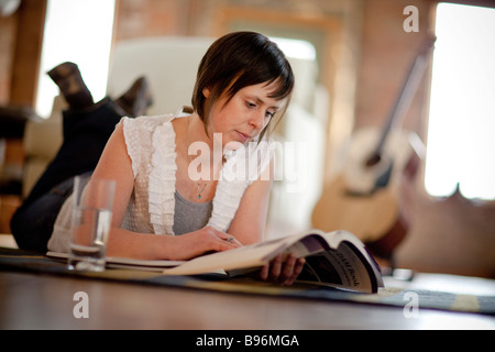 Young woman studying in urban loft Stock Photo