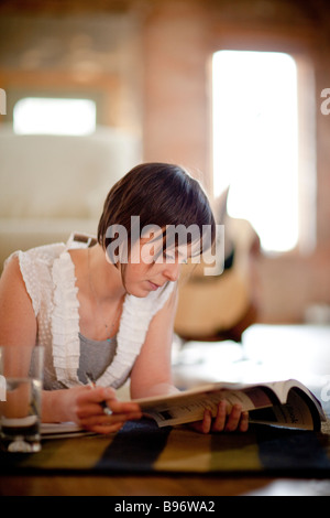 Young woman studying in urban loft Stock Photo