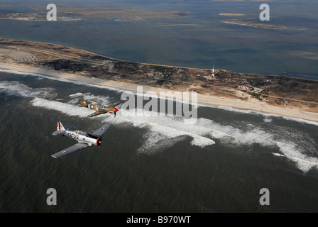 A 1935 silver T6 Texan and a 1935 Curtiss Wright P40 Warhawk flying over Robert Moses Park New York Stock Photo