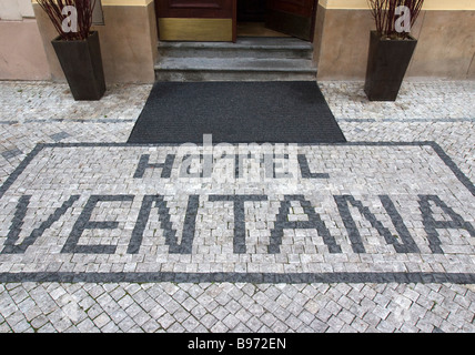 Cobblestone mosaic with hotel advertisment. Stock Photo