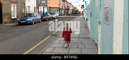 Five Year Old Girl Walking in a Salisbury Street Wiltshire Stock Photo