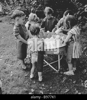 1950s GROUP BOYS AND GIRLS PLAYING GEOGRAPHY BOARD GAME IN CLASSROOM ...