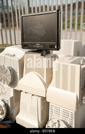 Computer monitors and a flat screen TV awaiting recycling at Aberystwyth recycling centre Wales UK WEEE compliant Stock Photo