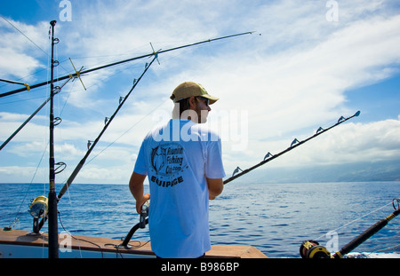 Big game fishing fisherman on fishing boat Saint Gilles La Réunion France | Hochseeangeln, Angler auf Fischerboot mit Angelruten Stock Photo