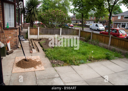 Picture shows the footings of a small wall in a front garden with the next mix of concrete ready to be produced Stock Photo