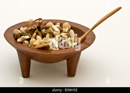 Fiji Kava bowl filled with nuts, with a wooden spoon Stock Photo