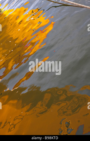 Colourful boat reflections in Poole Harbour in Summer Stock Photo