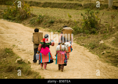 colorful Flower Hmong couples walking home from market in Cau Son near Bac Ha Vietnam Stock Photo