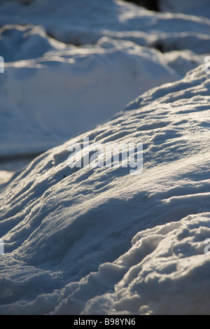 Banks of snow in the evening sun, showning sparkling snow crystals Stock Photo