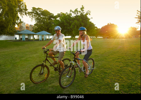 Couple riding bikes in the park Stock Photo
