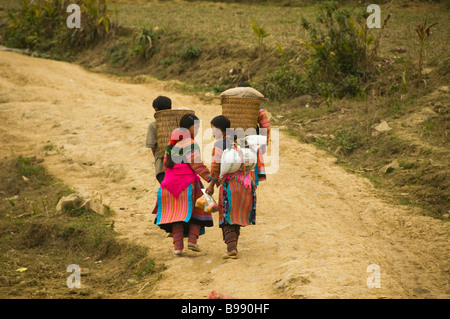 colorful Flower Hmong couples walking home from market in Cau Son near Bac Ha Vietnam Stock Photo