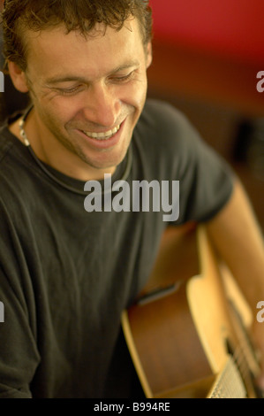 Young guy playing acousic guitar Stock Photo