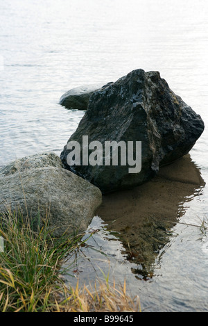 Boulders in shallow water Stock Photo