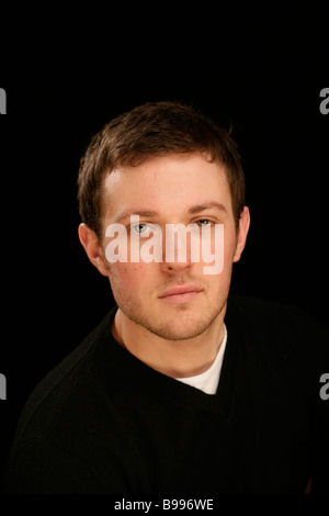 young handsome man head and shoulders cool confident assured Stock Photo
