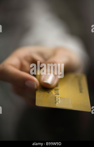 Woman's hand holding out credit card, extreme close-up Stock Photo