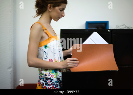 Casually dressed woman looking at files Stock Photo