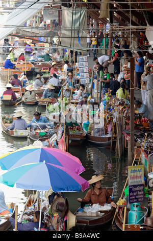 Selling food and souvenirs at the Damnoen Saduak floating market located about 62 miles outside of Bangkok Thailand Stock Photo