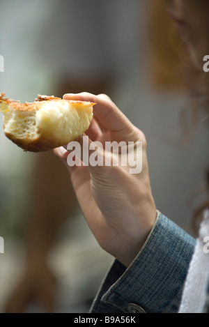 Woman's hand holding croissant, close-up Stock Photo
