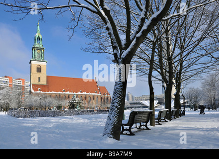 snow at Neptun fountain in Berlin center with St. marien church 2009 Stock Photo