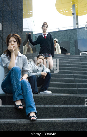 Young friends relaxing on steps, low angle view Stock Photo
