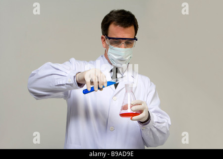 Scientist mixing liquids Stock Photo