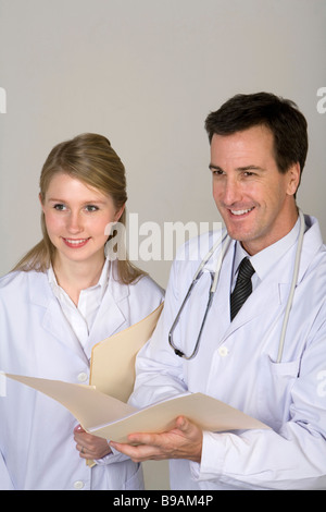Doctors consulting over patient file Stock Photo