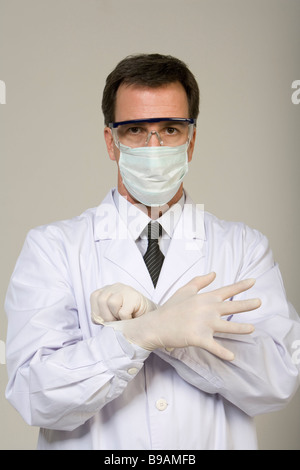 Male doctor wearing protective mask and gloves Stock Photo
