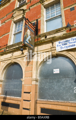 Boarded-up pub King William IV pub on main shopping street of Newport South Wales UK Stock Photo