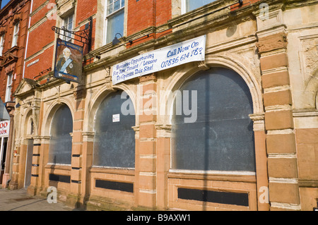 Boarded up pub King William IV pub on main shopping street in Newport South Wales UK Stock Photo