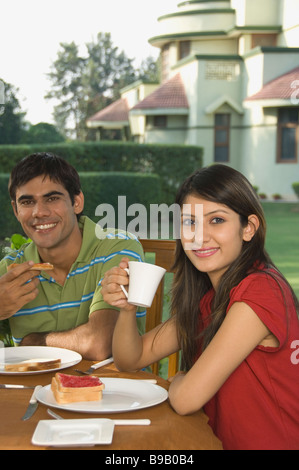 Couple having breakfast and smiling Stock Photo