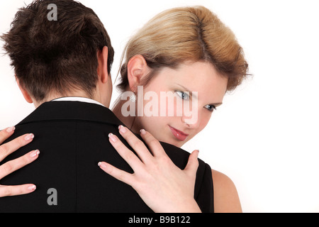 Portrait of young couple in embrace dancing, studio shot Stock Photo