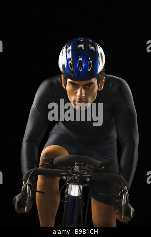 Male cyclist riding a racing bicycle Stock Photo