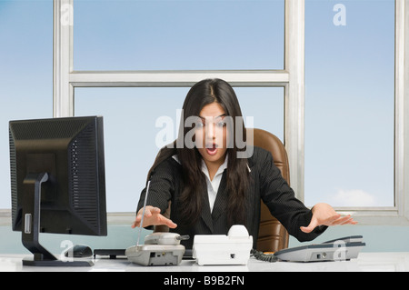 Businesswoman looking shocked in an office Stock Photo