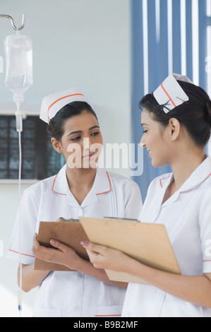Two female nurses holding clipboards Stock Photo