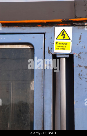 Danger overhead live wires sign on train carriage Stock Photo