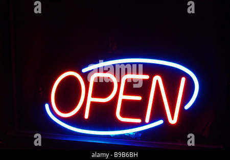 open sign  neon orange blue against black background nighttime Stock Photo