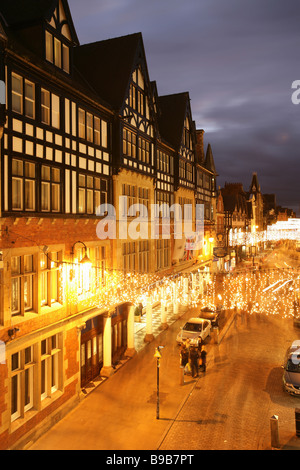 City of Chester, England. Elevated night view of a busy Christmas shopping scene at Chester’s Eastgate. Stock Photo